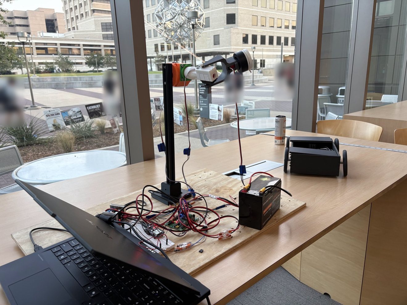 The CNTR arm on its test board with the wiring harness, ESP32 control electronics and battery, set up for a run.