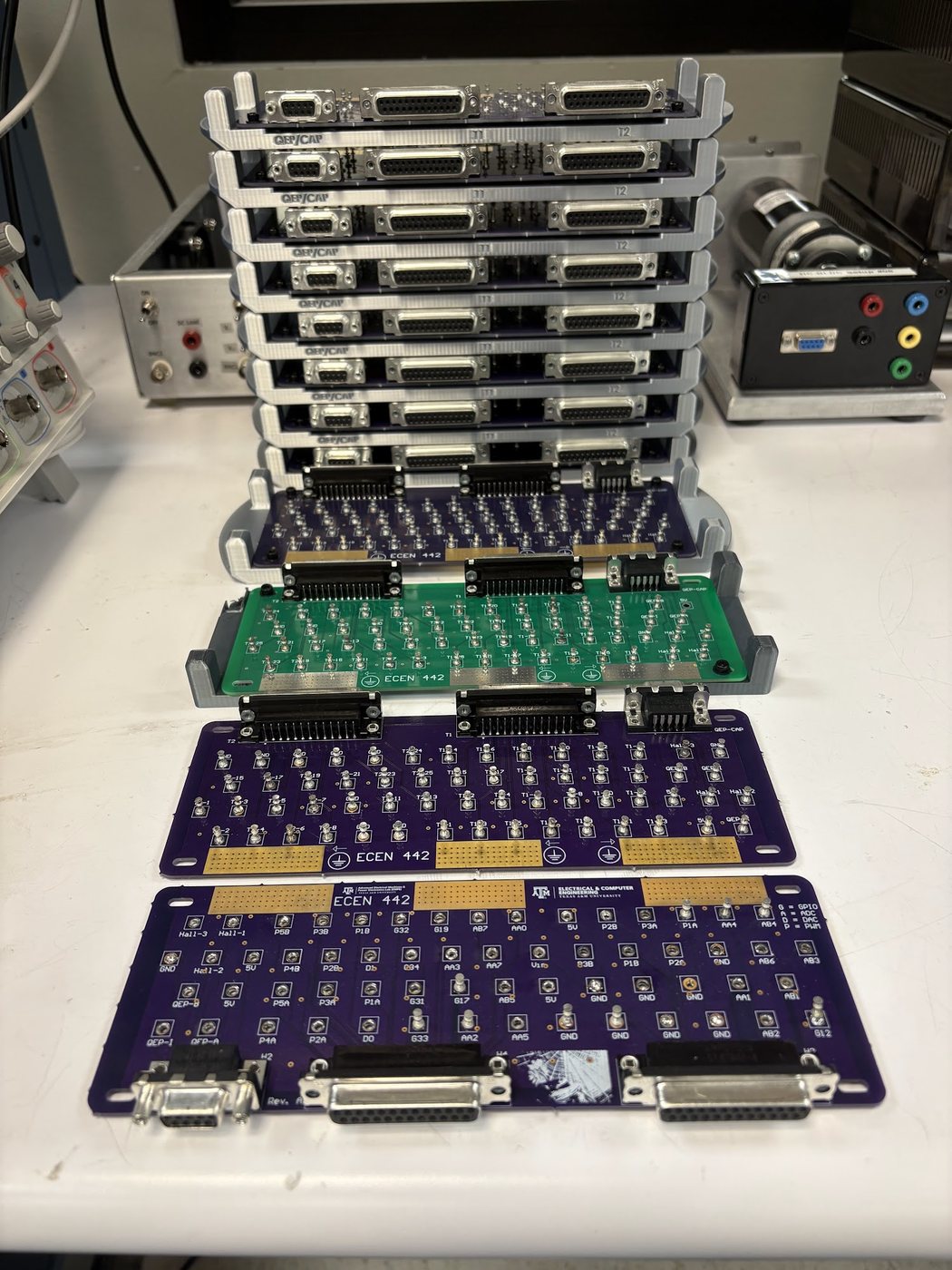 The stack of finished boards on the bench, with more boards laid out in front.