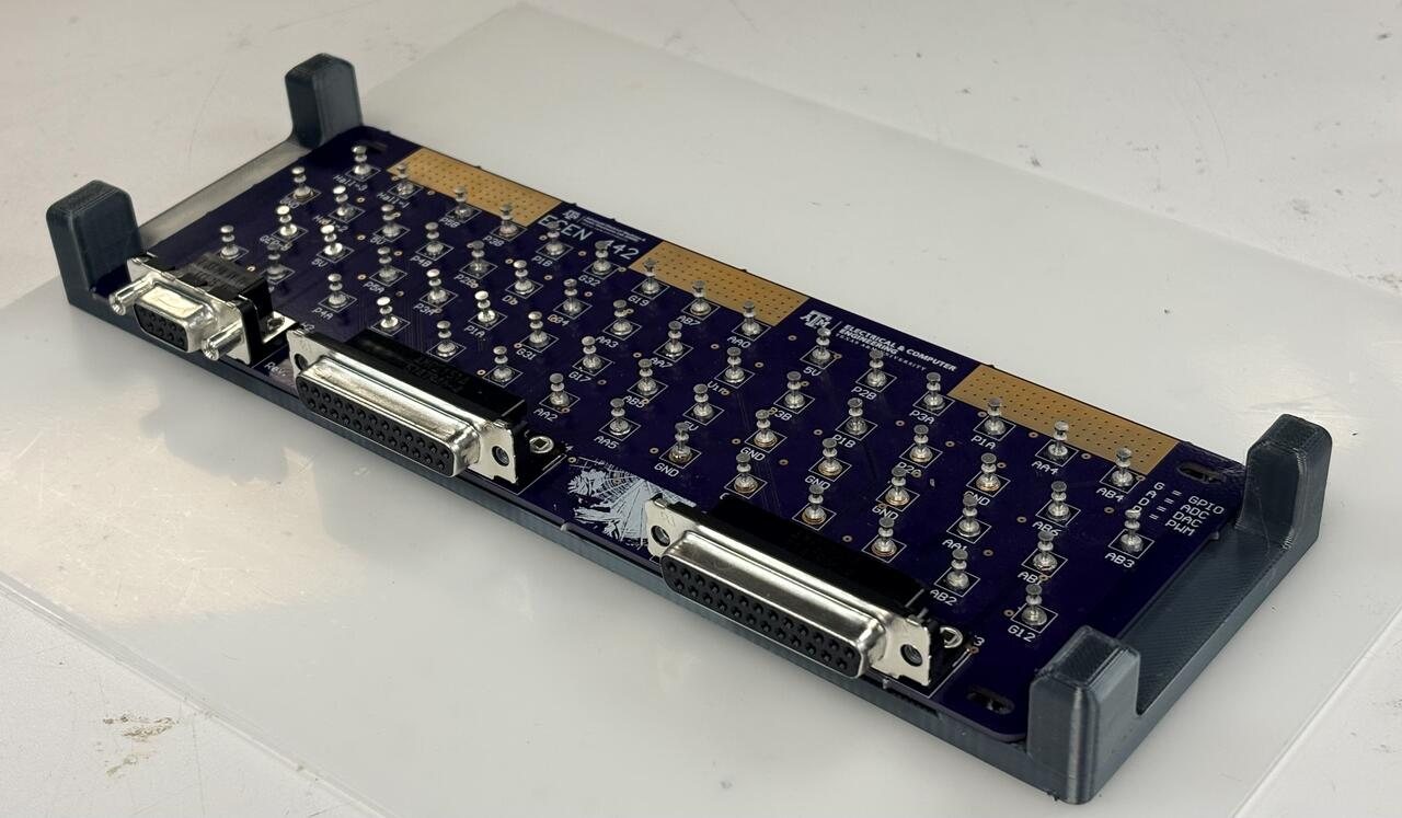 A fabricated board seated in its holder, seen from the connector end.