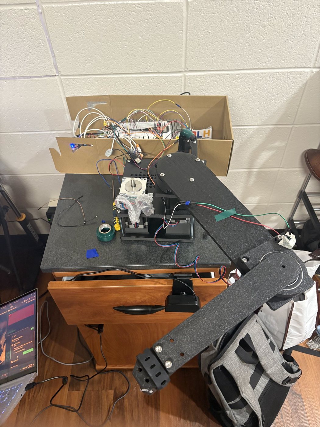 The built SCARA arm with its stepper drivers and power distribution wired up in the box behind it.