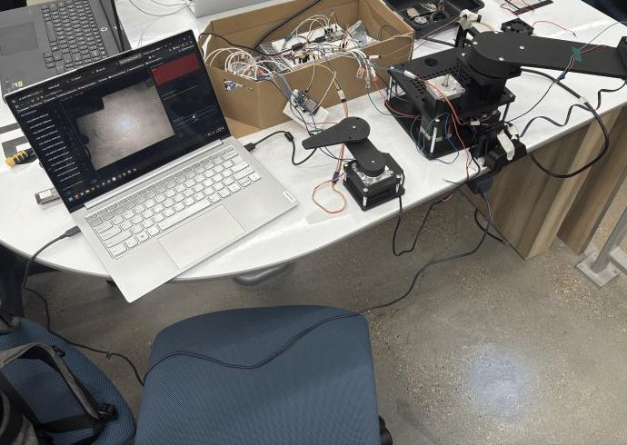 Running at TAMUhack, with the camera feed for hand tracking on the laptop.